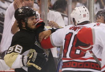 PITTSBURGH - MAY 21: Ryan Bayda #18 of the Carolina Hurricanes hits Kris Letang #58 of the Pittsburgh Penguins in the closing minutes of Game Two of the Eastern Conference Championship Round of the 2009 Stanley Cup Playoffs at Mellon Arena on May 21, 2009 in Pittsburgh, Pennsylvania. (Photo by Bruce Bennett/Getty Images)