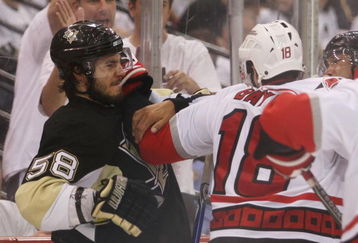 PITTSBURGH - MAY 21: Ryan Bayda #18 of the Carolina Hurricanes hits Kris Letang #58 of the Pittsburgh Penguins in the closing minutes of Game Two of the Eastern Conference Championship Round of the 2009 Stanley Cup Playoffs at Mellon Arena on May 21, 2009 in Pittsburgh, Pennsylvania. (Photo by Bruce Bennett/Getty Images)