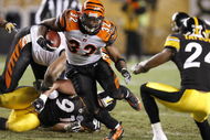 PITTSBURGH - NOVEMBER 20:  Cedric Benson #32 of the Cincinnati Bengals runs with the ball as  Ike Taylor #24 of the Pittsburgh Steelers defends during a first-quarter run on November 20, 2008 at Heinz Field in Pittsburgh, Pennsylvania.  (Photo by Gregory Shamus/Getty Images)