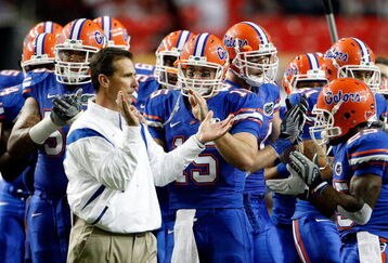 ATLANTA - DECEMBER 06:  Head coach Urban Meyer, quarterback Tim Tebow #15 and the Florida Gators prepare to face the Alabama Crimson Tide in the SEC Championship on December 6, 2008 at the Georgia Dome in Atlanta, Georgia.  (Photo by Kevin C. Cox/Getty Images)