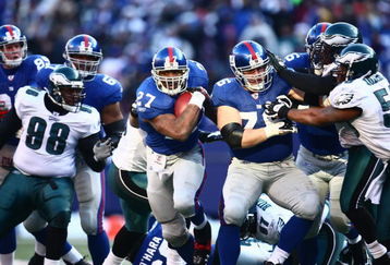 EAST RUTHERFORD, NJ -  JANUARY 11:  Brandon Jacobs #27 of the New York Giants runs the ball against the Philadelphia Eagles during the NFC Divisional Playoff Game on January 11, 2009 at Giants Stadium in East Rutherford, New Jersey.  The Eagles defeated the Giants 23 -11. (Photo by Chris McGrath/Getty Images)