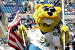 The Jacksonville Jaguars mascot leads the team to the field amid flying flags.  The Buffalo  Bills defeated the Jaguars 38 - 17  (Photo by Al Messerschmidt/Getty Images)