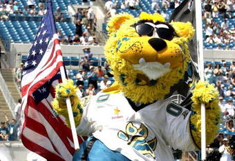 The Jacksonville Jaguars mascot leads the team to the field amid flying flags.  The Buffalo  Bills defeated the Jaguars 38 - 17  (Photo by Al Messerschmidt/Getty Images)