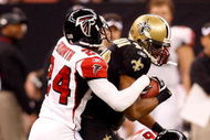 NEW ORLEANS - DECEMBER 07:  Devery Henderson #19 of the New Orleans Saints is tackled by Domonique Foxworth #24 and Keith Brooking #56 of the Atlanta Falcons on December 7, 2008 at the Superdome in New Orleans, Louisiana.  (Photo by Chris Graythen/Getty Images)