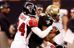 NEW ORLEANS - DECEMBER 07:  Devery Henderson #19 of the New Orleans Saints is tackled by Domonique Foxworth #24 and Keith Brooking #56 of the Atlanta Falcons on December 7, 2008 at the Superdome in New Orleans, Louisiana.  (Photo by Chris Graythen/Getty Images)