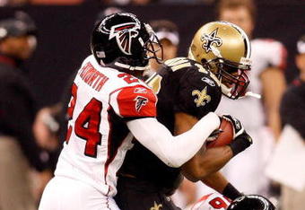 NEW ORLEANS - DECEMBER 07:  Devery Henderson #19 of the New Orleans Saints is tackled by Domonique Foxworth #24 and Keith Brooking #56 of the Atlanta Falcons on December 7, 2008 at the Superdome in New Orleans, Louisiana.  (Photo by Chris Graythen/Getty Images)