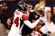 NEW ORLEANS - DECEMBER 07:  Devery Henderson #19 of the New Orleans Saints is tackled by Domonique Foxworth #24 and Keith Brooking #56 of the Atlanta Falcons on December 7, 2008 at the Superdome in New Orleans, Louisiana.  (Photo by Chris Graythen/Getty Images)