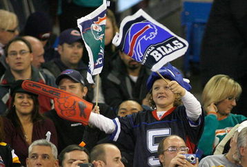 TORONTO, ON - DECEMBER 07: A young fan of the Buffalo Bills waves flags during play against the Miami Dolphins on December 7, 2008  at Rogers Centre in Toronto, Ontario, Canada. The Dolphins won 16-3. (Photo by Rick Stewart/Getty Images)