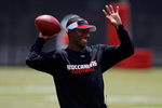 TAMPA - MAY 01:  Head coach Raheem Morris of the Tampa Bay Buccaneers warms up during the Buccaneers Rookie Minicamp at One Buccaneer Place on May 1, 2009 in Tampa, Florida.  (Photo by J. Meric/Getty Images)
