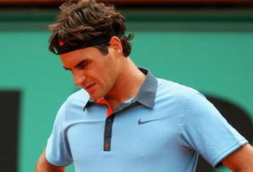 PARIS - MAY 28:  Roger Federer of Switzerland looks dejected during his Men's Singles Second Round match against Jose Acasuso of Argentina on day five of the French Open at Roland Garros on May 28, 2009 in Paris, France.  (Photo by Matthew Stockman/Getty Images)