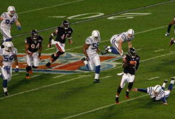 MIAMI GARDENS, FL - FEBRUARY 04:  Kick returner Devin Hester #23 of the Chicago Bears returns the opening kickoff 92-yards for a touchdown past a diving Adam Vinatieri #4 of the Indianapolis Colts in the first quarter of Super Bowl XLI on February 4, 2007 at Dolphin Stadium in Miami Gardens, Florida. The Colts won 29-17. (Photo by Eliot J. Schechter/Getty Images)