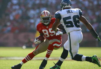 SAN FRANCISCO - OCTOBER 26:  Tight end Vernon Davis #85 of the San Francisco 49ers carries the ball while being pursued by Leroy Hill #56 of the Seattle Seahawks in the fourth quarter at Candlestick Park on October 26, 2008 in San Francisco, California. The Seahawks defeated the 49ers 34-13.  (Photo by Jeff Gross/Getty Images)