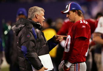 EAST RUTHERFORD, NJ - DECEMBER 03:  Eli Manning #10 of the New York Giants talks with Quarterbacks coach Kevin Gilbride before a game against the Dallas Cowboys at Giants Stadium on December 3, 2006 in East Rutherford, New Jersey.  (Photo by Chris McGrath/Getty Images)