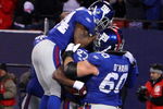 EAST RUTHERFORD, NJ - DECEMBER 21:  Running back Brandon Jacobs #27 of the New York Giants celebrates with teammates Derrick Ward #34 and Shaun O'Hara #60 in the end zone after scoring a touchdown against the Carolina Panthers in over time on December 21, 2008 at Giants Stadium in East Rutherford, New Jersey. The Giants defeated the Panthers 28 to 34.  (Photo by Jim McIsaac/Getty Images)