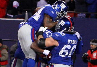 EAST RUTHERFORD, NJ - DECEMBER 21:  Running back Brandon Jacobs #27 of the New York Giants celebrates with teammates Derrick Ward #34 and Shaun O'Hara #60 in the end zone after scoring a touchdown against the Carolina Panthers in over time on December 21, 2008 at Giants Stadium in East Rutherford, New Jersey. The Giants defeated the Panthers 28 to 34.  (Photo by Jim McIsaac/Getty Images)