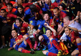 ROME - MAY 27:  Barcelona players pose in front of the trophy after they celebrate winning the UEFA Champions League Final match between Barcelona and Manchester United at the Stadio Olimpico on May 27, 2009 in Rome, Italy. Barcelona won 2-0.  (Photo by Shaun Botterill/Getty Images)