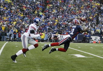 ORCHARD PARK, NY - DECEMBER 23:  Roscoe Parrish #11 of the Buffalo Bills makes 42 yard pass reception against Corey Webster #23 of the New York Giants on December 23, 2007 at Ralph Wilson Stadium in Orchard Park, New York.  (Photo by Rick Stewart/Getty Images)