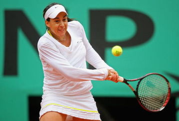 PARIS - MAY 28:  Marion Bartoli of France hits a backhand during her Women's Singles Second Round match against Tathiana Garbin of Italy on day five of the French Open at Roland Garros on May 28, 2009 in Paris, France.  (Photo by Matthew Stockman/Getty Images)
