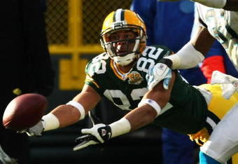 GREEN BAY, WI - NOVEMBER 18: Ruvell Martin #82 of the Green Bay Packers stretches to try and make a catch as Richard Marshall #31 of the Carolina Panthers defends on November 18, 2007 at Lambeau Field in Green Bay, Wisconsin. The Packers defeated the Panthers 31-17. (Photo by Jonathan Daniel/Getty Images)