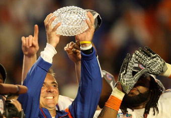 MIAMI - JANUARY 08:  Head coach Urban Meyer of the Florida Gators celebrates with the National Championship trophy after therir 24-14 win against the Oklahoma Sooners during the FedEx BCS National Championship game at Dolphin Stadium on January 8, 2009 in Miami, Florida.  (Photo by Doug Benc/Getty Images)