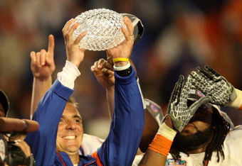 MIAMI - JANUARY 08:  Head coach Urban Meyer of the Florida Gators celebrates with the National Championship trophy after therir 24-14 win against the Oklahoma Sooners during the FedEx BCS National Championship game at Dolphin Stadium on January 8, 2009 in Miami, Florida.  (Photo by Doug Benc/Getty Images)