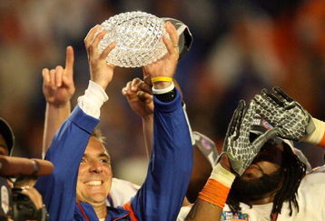 MIAMI - JANUARY 08:  Head coach Urban Meyer of the Florida Gators celebrates with the National Championship trophy after therir 24-14 win against the Oklahoma Sooners during the FedEx BCS National Championship game at Dolphin Stadium on January 8, 2009 in Miami, Florida.  (Photo by Doug Benc/Getty Images)
