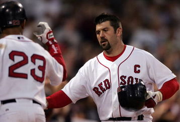 BOSTON - MAY 29:  Jason Varitek #33 of the Boston Red Sox is congratulated by teammate Julio Lugo #23 after Varitek hit a solo home run in the fifth inning against the Cleveland Indians at Fenway Park May 29, 2007 in Boston, Massachusetts.  (Photo by Elsa/Getty Images)