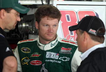 DOVER, DE - MAY 29:  Dale Earnhardt Jr. (C), driver of the #88 AMP Energy/National Guard Chevrolet, talks with interim crew chief Brian Whitesell (R) and a crew member in the garage during practice for the NASCAR Sprint Cup Series Autism Speaks 400 at Dover International Speedway on May 29, 2009 in Dover, Delaware.  (Photo by Nick Laham/Getty Images)