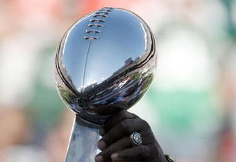 EAST RUTHERFORD, NJ - OCTOBER 26:  Members of the 1968 Jets touch the Lombardi Trophy during halftime festivities celebrating the 40th anniversary of the team's win over the Colts in Super Bowl III during the game between the Kansas City Chiefs and the New York Jets on October 26, 2008 at Giants Stadium in East Rutherford, New Jersey.  (Photo by Jarrett Baker/Getty Images)