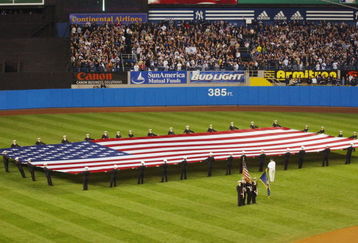 NEW YORK - NOVEMBER 01:  Members of the New York City Fire Department stetch the U.S. flag on the outfield for the National Anthem before game five of the 2001 World Series between the Arizona Diamonbacks and the New York Yankees at Yankee Stadium in New York, New York on October 31, 2001.  The Yankees defeated the Diamonbacks 3-2.  (Photo by Doug Pensinger/Getty Images) 