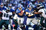EAST RUTHERFORD, NJ -  JANUARY 11:  Brandon Jacobs #27 of the New York Giants runs the ball against the Philadelphia Eagles during the NFC Divisional Playoff Game on January 11, 2009 at Giants Stadium in East Rutherford, New Jersey.  The Eagles defeated the Giants 23 -11. (Photo by Chris McGrath/Getty Images)