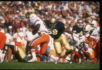 15 Oct 1988:  George Williams of the Notre Dame Fighting Irish (right) attempts to tackle a Miami Hurricanes player during a game at Notre Dame Stadium in South Bend, Indiana.  Notre Dame won the game, 31-30. Mandatory Credit: Jonathan Daniel  /Allsport