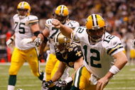 NEW ORLEANS - NOVEMBER 24: Quarterback Aaron Rodgers #12 of the Green Bay Packers celebrates after scoring a touchdown in the second quarter against the New Orleans Saints on November 24, 2009 at the Superdome in New Orleans, Louisiana. (Photo by Chris Graythen/Getty Images)
