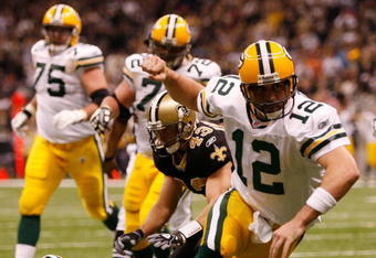 NEW ORLEANS - NOVEMBER 24:  Quarterback Aaron Rodgers #12 of the Green Bay Packers celebrates after scoring a touchdown in the second quarter against the New Orleans Saints on November 24, 2009 at the Superdome in New Orleans, Louisiana.  (Photo by Chris Graythen/Getty Images)