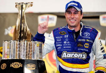 CONCORD, NC - MAY 25:  David Reutimann, driver of the #00 Aaron's Dream Machine Toyota, poses in victory lane after winning the NASCAR Sprint Cup Series Coca-Cola 600 on May 25, 2009 at Lowe's Motor Speedway in Concord, North Carolina. Reutimann won the Coca-Cola 600 due to a rain out on lap 227.  (Photo by Rusty Jarrett/Getty Images for NASCAR)