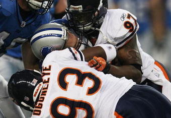 DETROIT - SEPTEMBER 30: Mark Anderson #97 and Adewale Ogunleye #93 of the Chicago Bears sack Jon Kitna #8 of the Detroit Lions, who fumbles the ball, in the first quarter on September 30, 2007 at Ford Field in Detroit, Michigan. The Lions defeated the Bears 37-27. (Photo by Jonathan Daniel/Getty Images)