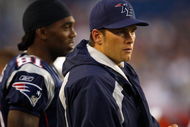 FOXBORO, MA - AUGUST 7: Randy Moss #81 and Tom Brady #12 of the New England Patriots watch the game on the sidelines against the Baltimore Ravens during a preseason game at Gillette Stadium on August 7, 2008 in Foxboro, Massachusetts. (Photo by Jim Rogash/Getty Images)