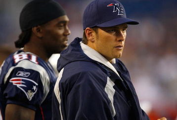 FOXBORO, MA - AUGUST 7:  Randy Moss #81 and Tom Brady #12 of the New England Patriots watch the game on the sidelines against the Baltimore Ravens during a preseason game at Gillette Stadium on August 7, 2008 in Foxboro, Massachusetts. (Photo by Jim Rogash/Getty Images)