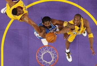 LOS ANGELES, CA - MAY 21:  Nene #31 of the Denver Nuggets goes to the basket against Andrew Bynum #17 and Kobe Bryant #24 of the Los Angeles Lakers in Game Five of the Western Conference Finals during the 2009 NBA Playoffs at Staples Center on May 27, 2009 in Los Angeles, California. NOTE TO USER: User expressly acknowledges and agrees that, by downloading and or using this photograph, User is consenting to the terms and conditions of the Getty Images License Agreement. (Photo by Kevork Djansezian/Getty Images)
