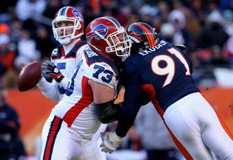 DENVER - DECEMBER 21:  Offensive tackle Kirk Chambers #73 of the Buffalo Bills blocks the rush of Ebenezer Ekuban #91 of the Denver Broncos as he protects quarterback Trent Edwards #5 at Invesco Field at Mile High on December 21, 2008 in Denver, Colorado. The Bills defeated the Broncos 30-23.  (Photo by Doug Pensinger/Getty Images)