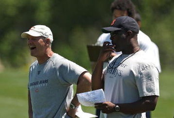LAKE FOREST, IL - MAY 20: Head coach Lovie Smith of the Chicago Bears (R) and defensive line coach Rod Marinelli watch an organized team activity (OTA) practice on May 20, 2009 at Halas Hall in Lake Forest, Illinois. (Photo by Jonathan Daniel/Getty Images)
