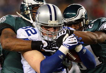 PHILADELPHIA - DECEMBER 28:  Omar Gaither #96 and Sheldon Brown #24 of the Philadelphia Eagles tackles Jason Witten #82 of the Dallas Cowboys on December 28, 2008 at Lincoln Financial Field in Philadelphia, Pennsylvania. The Eagles defeated the Cowboys 44-6.  (Photo by Jim McIsaac/Getty Images)