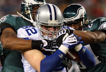 PHILADELPHIA - DECEMBER 28:  Omar Gaither #96 and Sheldon Brown #24 of the Philadelphia Eagles tackles Jason Witten #82 of the Dallas Cowboys on December 28, 2008 at Lincoln Financial Field in Philadelphia, Pennsylvania. The Eagles defeated the Cowboys 44-6.  (Photo by Jim McIsaac/Getty Images)