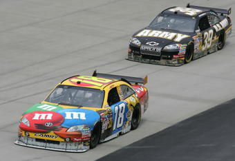 DOVER, DE - MAY 29:  Kyle Busch, driver of the #18 M&M's Toyota, leads Ryan Newman, driver of the #39 U.S. Army Chevrolet, during practice for the NASCAR Sprint Cup Series Autism Speaks 400 at Dover International Speedway on May 29, 2009 in Dover, Delaware.  (Photo by Todd Warshaw/Getty Images)