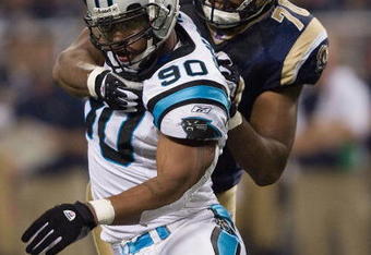 ST. LOUIS, MO - SEPTEMBER 9:  Julius Peppers #90 of the Carolina Panthers is grabbed from behind by Alex Barron #70 of the St. Louis Rams during the NFL game on September 9, 2007 at the Edward Jones Dome in St. Louis, Missouri.  The Panthers beat the Rams 27-13.  (Photo by Dilip Vishwanat/Getty Images)