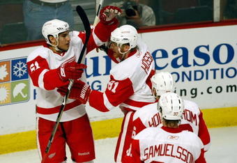 CHICAGO - MAY 24:  Valtteri Filppula #51 of the Detroit Red Wings celebrates with Marian Hossa #81, Tomas Holmstrom #96 and Mikael Samuelsson #37 after Filppula scored a goal in the second period against the Chicago Blackhawks during Game Four of the Western Conference Championship Round of the 2009 Stanley Cup Playoffs on May 24, 2009 at the United Center in Chicago, Illinois.  (Photo by Jim Prisching/Getty Images)
