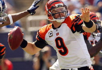 EAST RUTHERFORD, NJ - SEPTEMBER 21:  Carson Palmer #9 of the Cincinnati Bengals looks to pass as he is pressured by the New York Giants defense on September 21, 2008 at Giants Stadium in East Rutherford, New Jersey  (Photo by Elsa/Getty Images)