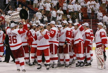 PITTSBURGH - JUNE 04: Tomas Holmstrom #96 of the Detroit Red Wings hands off to Brian Rafalski #28 as they celebrate with the Stanley Cup after defeating the Pittsburgh Penguins in game six of the 2008 NHL Stanley Cup Finals at Mellon Arena on June 4, 2008 in Pittsburgh. Pennsylvania. The Red Wings defeated the Penguins 3-2 to win the Stanley Cup Finals 4 games to 2. (Photo by Bruce Bennett/Getty Images)