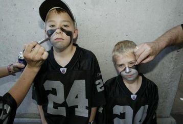 SAN DIEGO - JANUARY 26:  Fans Justin and Calvin Boller have their faces painted before the start of Super Bowl XXXVII between the Tampa Bay Buccaneers and the Oakland Raiders at Qualcomm Stadium on January 26, 2003 in San Diego, California.  The Buccaneers won 48-21.  (Photo by Donald Miralle/Getty Images)