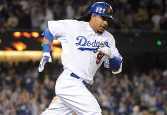 LOS ANGELES, CA - APRIL 30:  Manny Ramirez #99 of the Los Angeles Dodgers hits a homerun for a 4-3 lead against the San Diego Padres during the third inning at Dodger Stadium on April 30, 2009 in Los Angeles, California.  (Photo by Harry How/Getty Images)